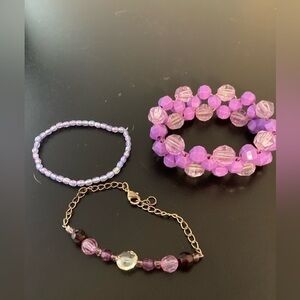 Three beaded pink bracelets.